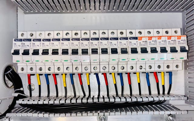 Neatly labelled circuit breakers in a switchboard