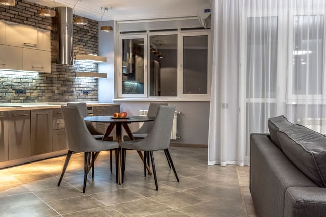 Open-plan kitchen and dining area with modern lighting