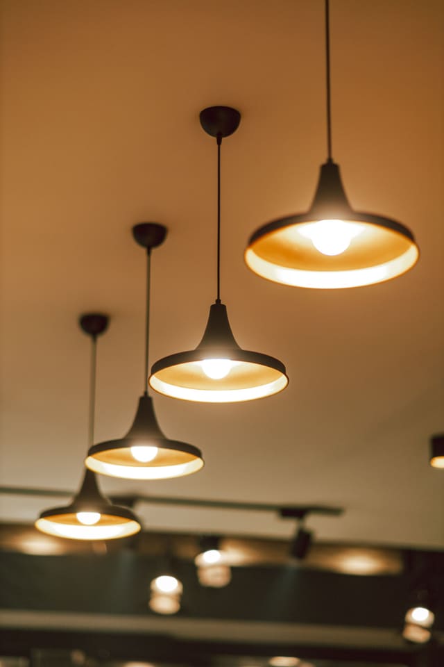 Black pendant lights with warm globes